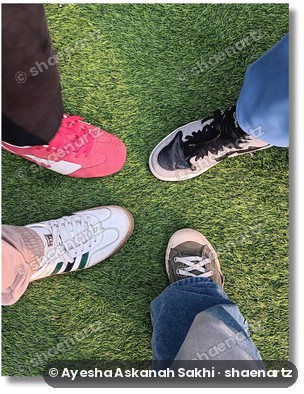 Phone photo of friends’ shoes on the grass